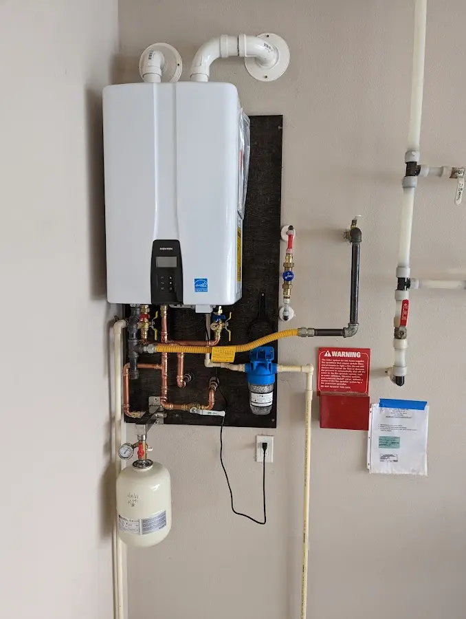 Professional plumber installing copper piping in a Hortonville home